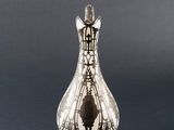 silver vase with a design on the body of a horse