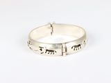 a close up of a silver ring with elephants on it