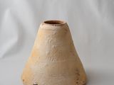 a small vase that is sitting on a white surface