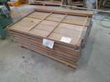 several pieces of wood are stacked on top of each other in a warehouse