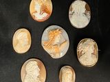 six different types of carved cameos on a black surface