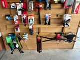 many tools hanging on the wall in the shop