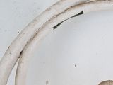 a close up of a white sink with a drain in it