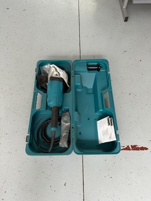 a blue tool in a blue case on the floor