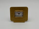 an image of a gold clock with roman numerals on a white background