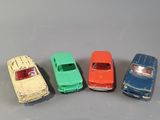 several toy cars are lined up in a row on a gray surface
