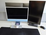 two computer monitors and a keyboard on a desk