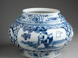 a blue and white vase sitting on a table