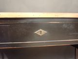 a black table with a drawer on top of it