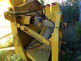 a large yellow machine that is sitting in the grass