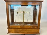 an old wooden case with a scale on top of it