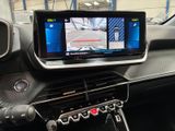 a car dashboard with a monitor and a steering wheel
