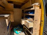 a yellow van that has a lot of drawers inside of it