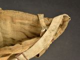 an old baseball glove with a leather strap on it