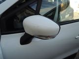 a small white car with a mirror on the side of it