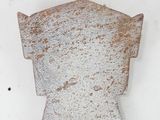 a rusted metal object on a white surface