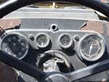a close up of a steering wheel and gauges on a vehicle