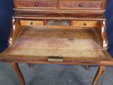 a wooden desk with a drawer on top of it