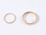 two gold wedding rings on a white background