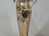 two silver vases sitting next to each other on a table