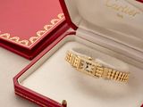 a red box with a gold bracelet inside of it