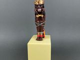 a close up of a small statue of a person on a pedestal