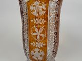 a glass vase with a floral design on it