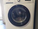 a washing machine sitting on the floor in front of a door