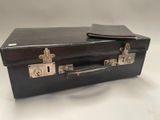 a black suitcase sitting on top of a white table
