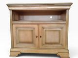 a wooden cabinet with a glass door on top of it