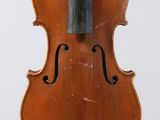 an old violin with a bow hanging from it ' s back