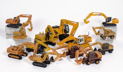 de nombreux engins de chantier miniatures posés sur une surface blanche