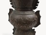 a large bronze vase with a design on it