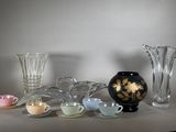 a lot of glass vases and cups on the table