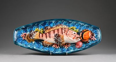 a glass fish that is sitting on top of a table