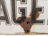 a rusted sign with a dog on it that says age