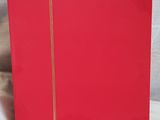 a red book with a gold zipper on it