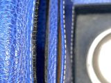 a close up of a blue purse with a coin inside of it