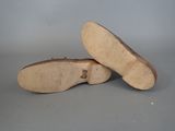 two pairs of shoes are shown on a gray surface