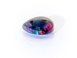 a black oplite gems with a multi - colored pattern on it