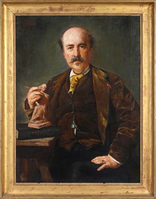 portrait of a man in a brown jacket and yellow tie sitting at a table