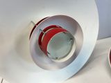 a red and white bowl and a red and white plate on a counter