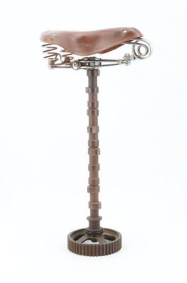 a bike seat that is on a stand on a white background