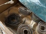 a box with a bunch of hair brushes inside of it