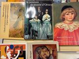 several books on a table with pictures of people on them