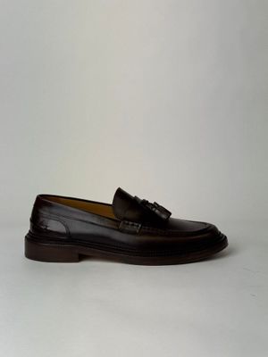 men ' s black leather loafers with tassels on the sole