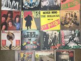 many different records are stacked on top of each other on the floor