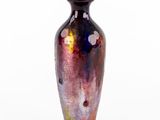 a vase that is sitting on a white surface
