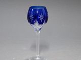 a blue wine glass sitting on top of a table
