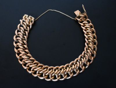 an image of a gold chain necklace on a black background